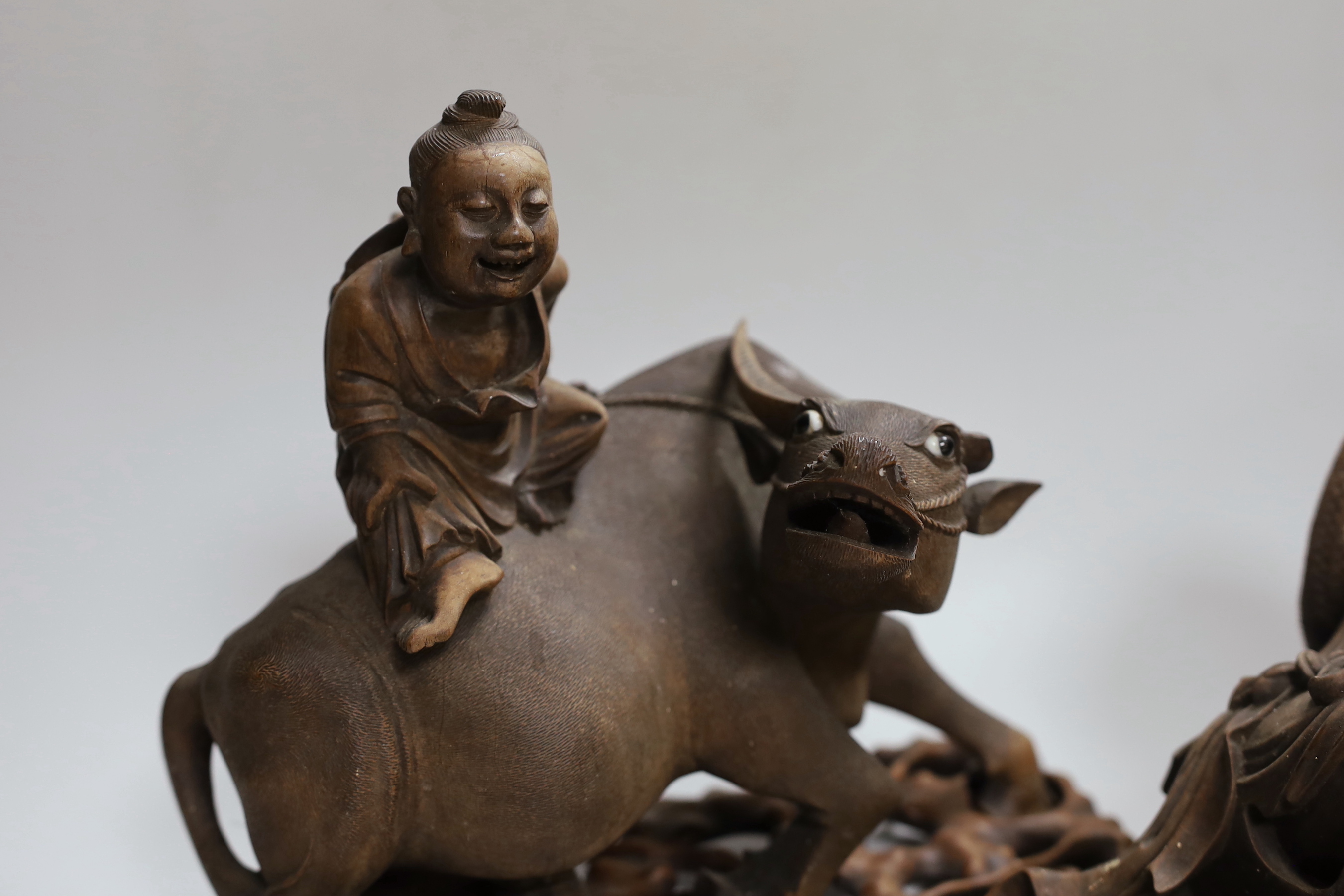 Two Chinese carved hardwood figure groups on stands, early 20th century, largest 30cm long